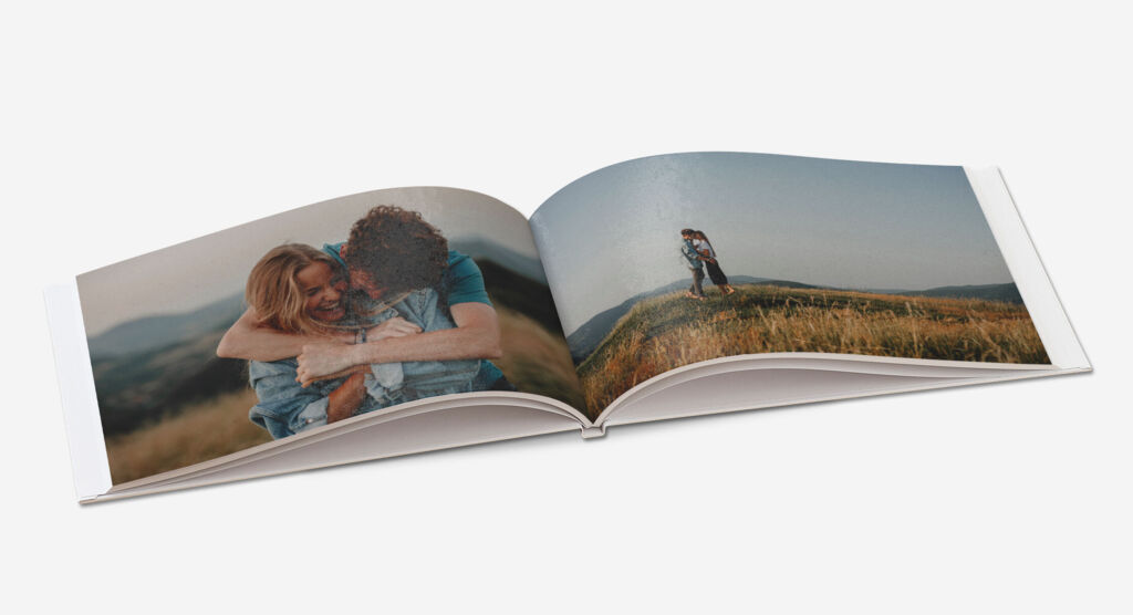 Aufgeschlagenes A4 Quer Fotobuch mit Bildern von einem Paar.