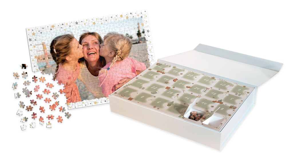 Adventskalender in einer Klappschachtel mit Puzzleteilen hinter jedem Türchen, daneben ein Puzzle mit Familienfoto