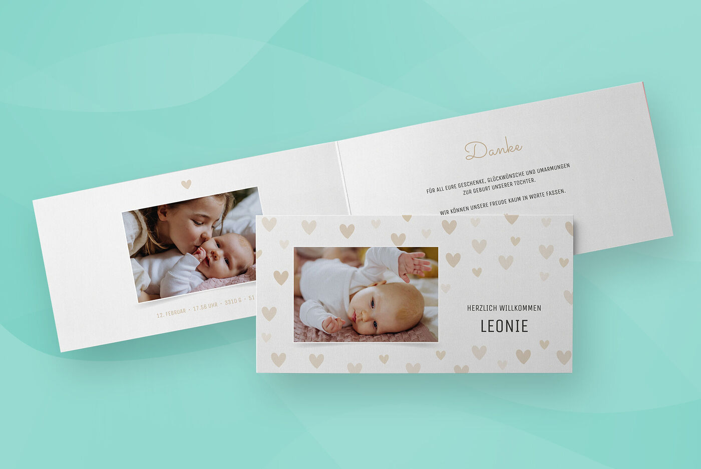 Eine längliche Klappkarte im Querformat mit Babyfotos steht vor einem grünen Hintergrund